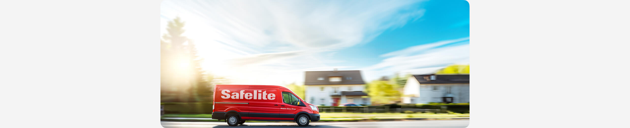 A Safelite Mobile Glass Shop vehicle driving on a street